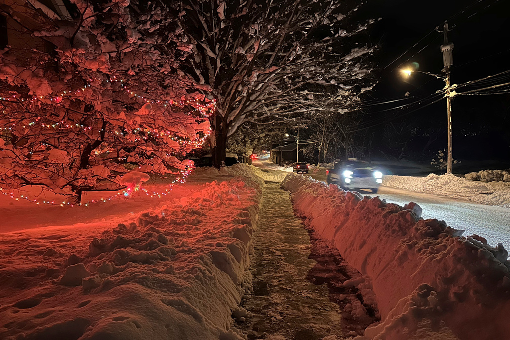 FILE - Drivers take advantage of the lull between lake-effect snowfalls in Lowville, N.Y., on Nov. 30, 2024. (AP Photo/Cara Anna, File)