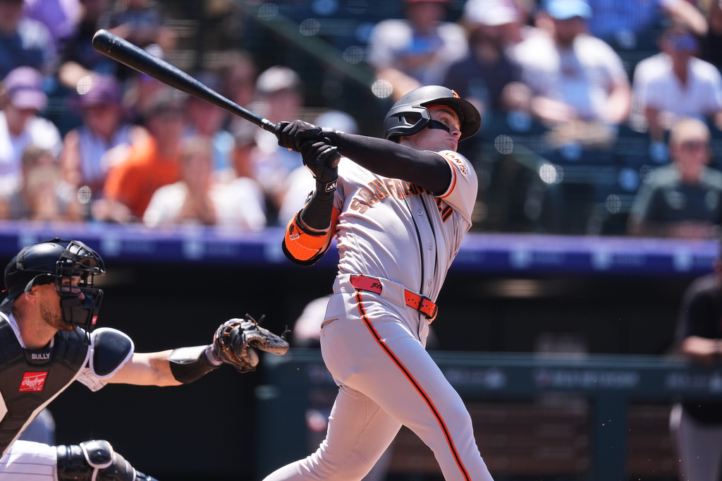 San Francisco Giants' Drew Gilbert follows through with his swing after connecting for a two-run home run off Colorado Rockies starting pitcher Tanner Gordon in the second inning of a baseball game Sunday, July 5, 2026, in Denver. (AP Photo/David Zalubowski)