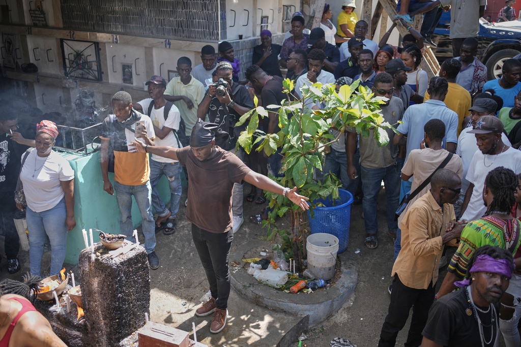 Devotees take part in the annual Fete Gede festival that celebrates Day of the Dead, honoring the Haitian spirits Baron Samedi and Gede, at a cemetery in Port-au-Prince, Haiti, Saturday, Nov. 1, 2025. (AP Photo/Odelyn Joseph)