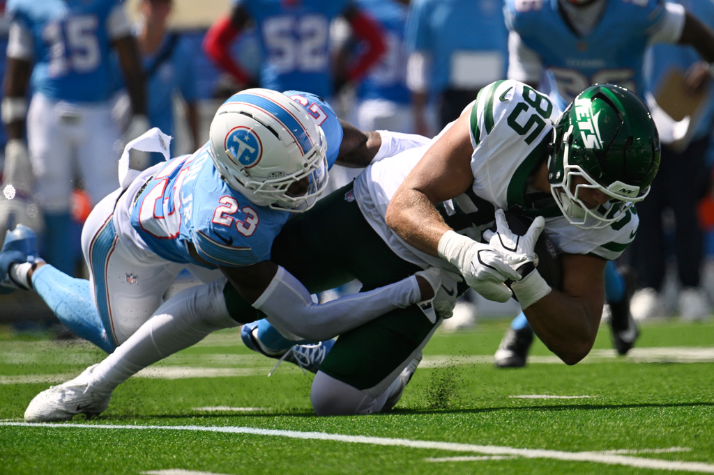 New York Jets tight end Mason Taylor (85) is tackled by Tennessee Titans safety Kevin Winston Jr. (23) during the first half of an NFL football game Sunday, Sept. 13, 2026, in Nashville, Tenn. (AP Photo/John Amis)