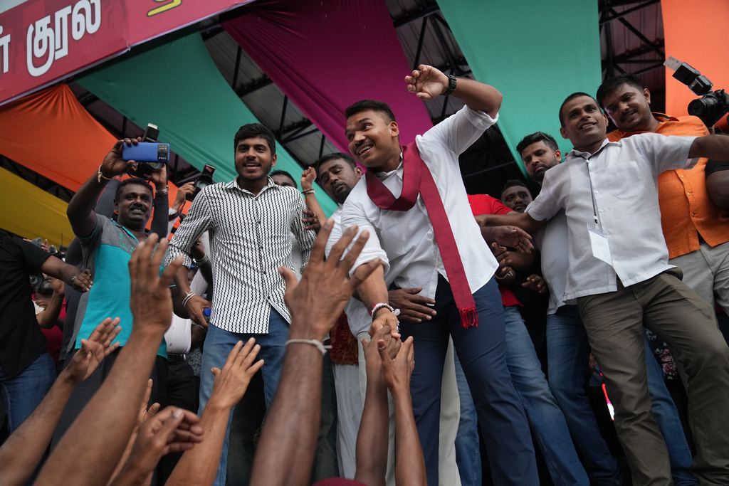 Sri Lankan lawmaker Namal Rajapaksa, heir to the once-powerful Rajapaksa dynasty, waves to supporters during a public rally in Colombo, Sri Lanka, Friday, Nov. 21, 2025. (AP Photo/Eranga Jayawardena)