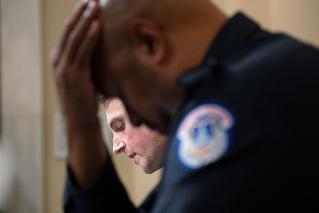 FILE - U.S. Capitol Police Sgt. Harry Dunn listens as Washington Metropolitan Police Department officer Daniel Hodges testifies before the House select committee hearing on the Jan. 6 attack on Capitol Hill in Washington, July 27, 2021. (Brendan Smialowski/Pool via AP, File)