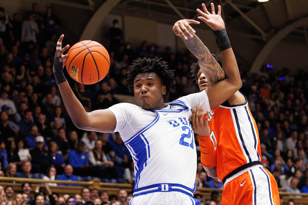 Duke's Patrick Ngongba II (21) grabs a rebound ahead of Syracuse's Sadiq White Jr. (0) during the first half of an NCAA college basketball game in Durham, N.C., Monday, Feb. 16, 2026. (AP Photo/Ben McKeown)