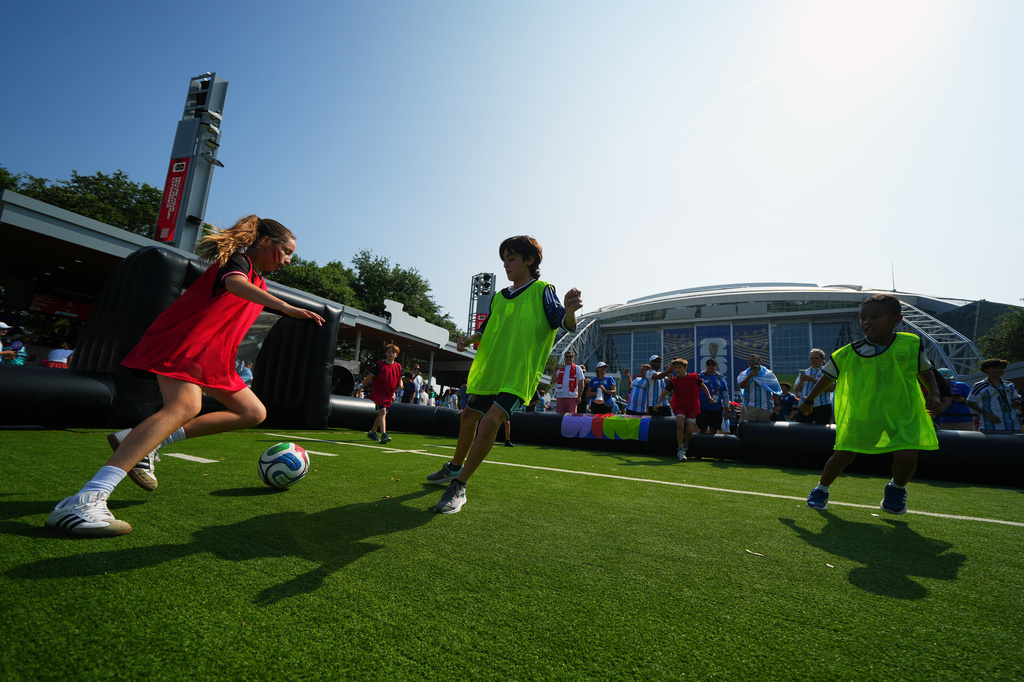 FILE - Children wearing shirts of Austria and Argentina play soccer outside the stadium before the World Cup Group J soccer match between Argentina and Austria in Arlington, Texas, near Dallas, Monday, June 22, 2026. (AP Photo/Julio Cortez,File)