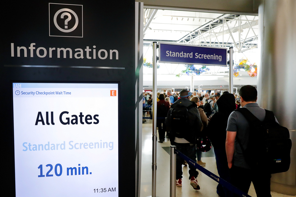 Air travelers endure long lines and two-hour wait times at the TSA security check point at Terminal E at the George Bush Intercontinental Airport Friday, March 20, 2026, in Houston. (AP Photo/Michael Wyke)