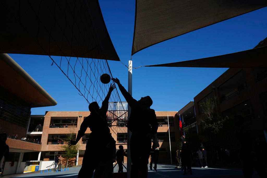 Students play volleyball at the Bicentenario School in Santiago, Chile, Monday, Sept. 8, 2025. (AP Photo/Esteban Felix)