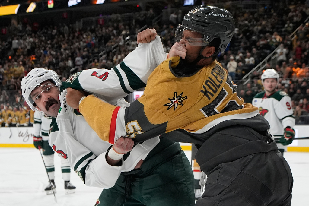 Minnesota Wild defenseman Jake Middleton, left, and Vegas Golden Knights right wing Keegan Kolesar (55) fight during the second period of an NHL hockey game Friday, March 6, 2026, in Las Vegas. (AP Photo/John Locher)
