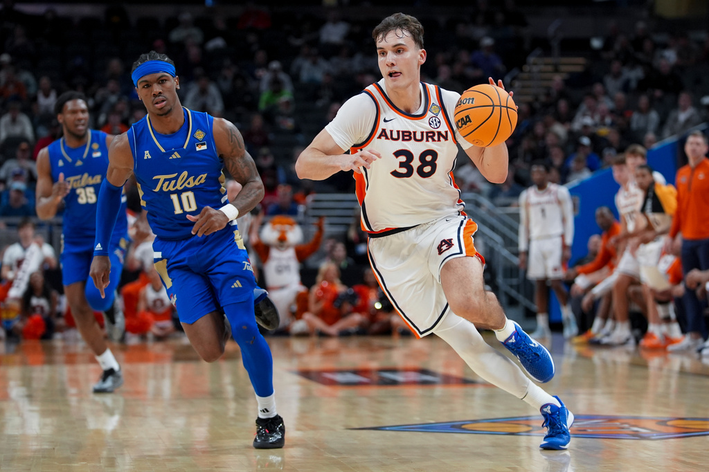 FILE - Auburn forward Filip Jovic (38) drives as Tulsa guard Tylen Riley (10) pursues during the first half of an NCAA college basketball NIT Championship game, April 5, 2026, in Indianapolis. (AP Photo/Abbie Parr, File)