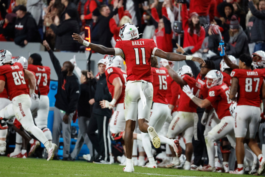 North Carolina State quarterback CJ Bailey (11) celebrates a touchdown pass against Georgia Tech during the second half of an NCAA college football game in Raleigh, N.C., Saturday, Nov. 1, 2025. (AP Photo/Karl DeBlaker)