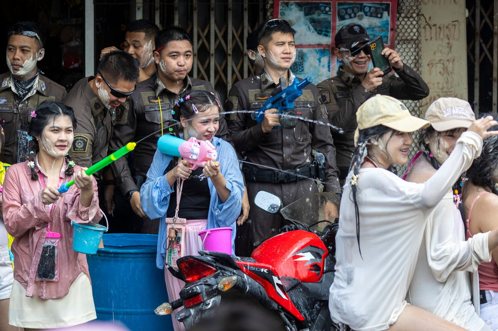 Thai policemen and peoples participate in the Songkran water festival to celebrate the Thai New Year in Prachinburi province, Thailand, Monday, April 13, 2026. (AP Photo/Wason Wanichakorn)