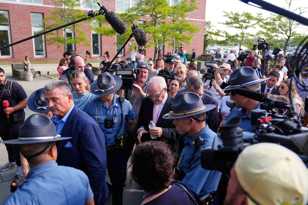 Defense attorney Kevin Reddington, center, leaves court, flanked by media and law enforcement, after the judge declared a mistrial in Lindsay Clancy's murder trial at Plymouth County Superior Court, Friday, Sept. 4, 2026, in Plymouth, Mass. (AP Photo/Charles Krupa)
