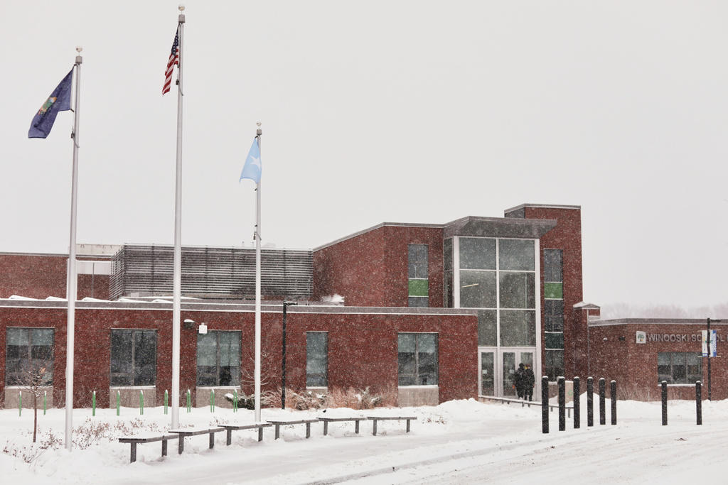 A Somali flag flies alongside the United States and Vermont flags outside the Winooski School District building, Wednesday, Dec. 10, 2025, in Winooski, Vt. (AP Photo/Amanda Swinhart)