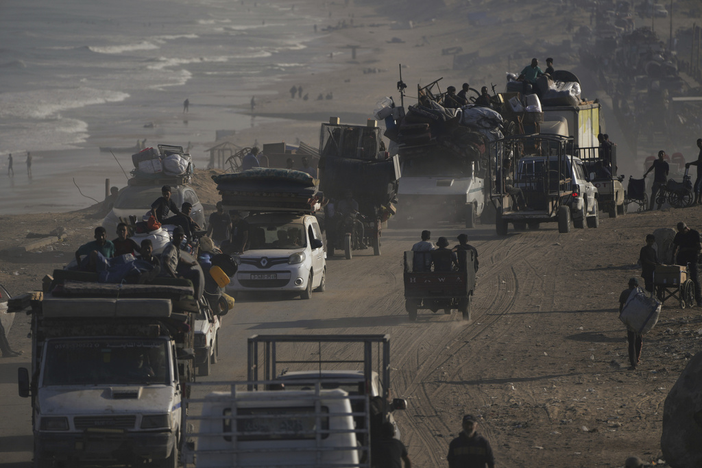 Displaced Palestinians flee Gaza City by foot and vehicles, carrying their belongings along the coastal road toward southern Gaza, Wednesday, Sept. 17, 2025. (AP Photo/Abdel Kareem Hana)