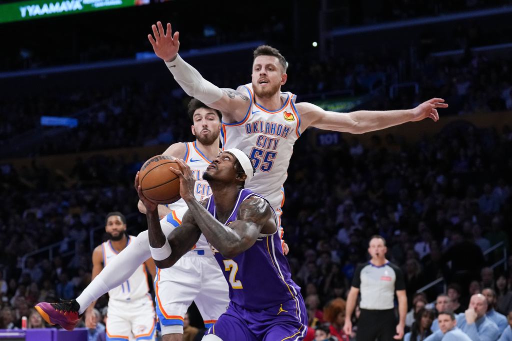 Los Angeles Lakers forward Jarred Vanderbilt (2) looks to shoot under pressure by Oklahoma City Thunder center Isaiah Hartenstein (55) during the first half of an NBA basketball game Monday, Feb. 9, 2026, in Los Angeles. (AP Photo/Jae C. Hong)