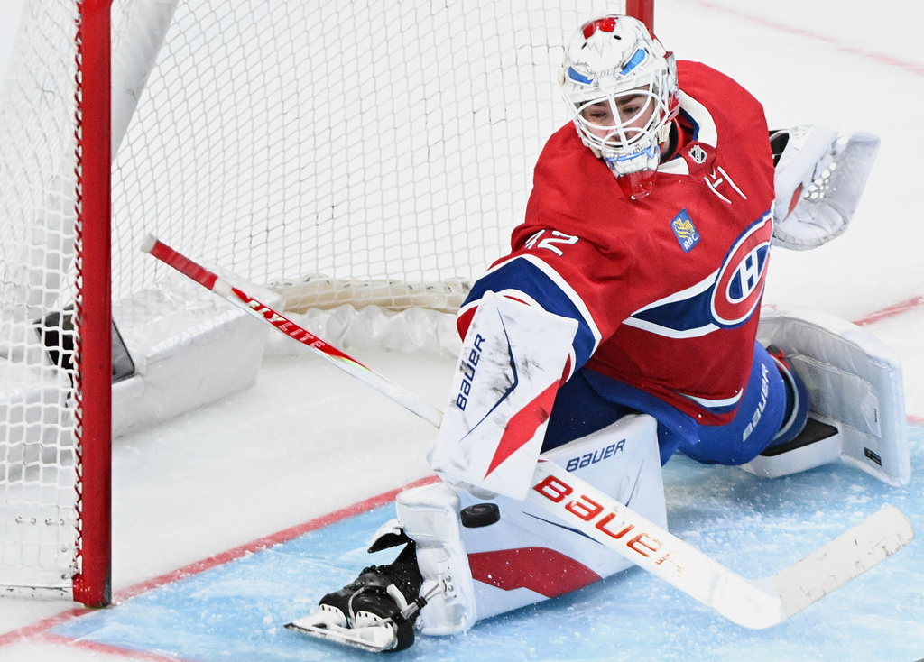Montreal Canadiens goaltender Jacob Fowler makes a save against the Pittsburgh Penguins during the second period of an NHL hockey game, in Montreal, Saturday, Dec. 20, 2025. (Graham Hughes/The Canadian Press via AP)