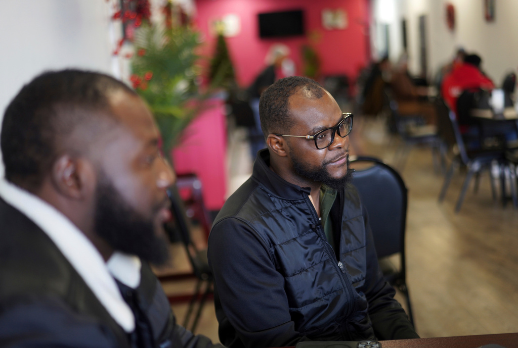 FILE - Viles Dorsainvil, executive director of the Haitian Community Help and Support Center at Rose Goute Creole Restaurant, sits with interpreter James Fleurijean, left, a board member of the Haitian Community Help and Support Center, in Springfield, Ohio, Jan. 25, 2025. (AP Photo/Jessie Wardarski, File)