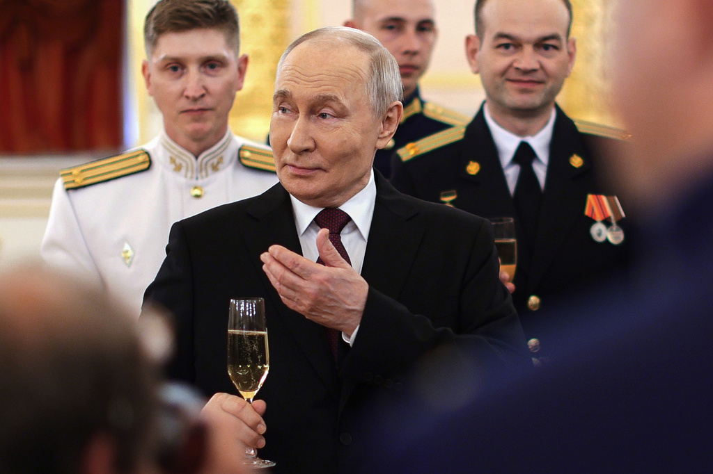 Russian President Vladimir Putin toasts with graduates of the country's highest military schools during a meeting at the Kremlin in Moscow, on Tuesday, June 23, 2026. (Gavriil Grigorov, Sputnik, Kremlin Pool Photo via AP)