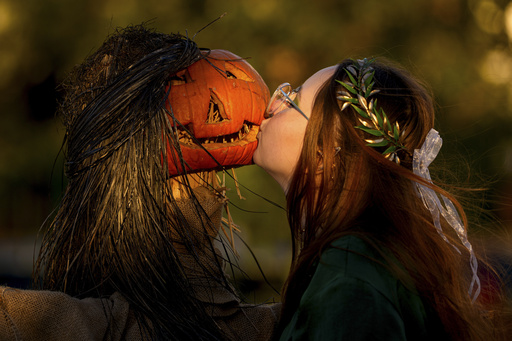 A girl poses for a friend while kissing a pumpkin at the West Side Hallo Fest, the country's largest Halloween festival in Bucharest, Romania, Friday, Oct. 24, 2025. (AP Photo/Andreea Alexandru) A girl poses for a friend while kissing a pumpkin at the West Side Hallo Fest, the country's largest Halloween festival in Bucharest, Romania, Friday, Oct. 24, 2025. (AP Photo/Andreea Alexandru)