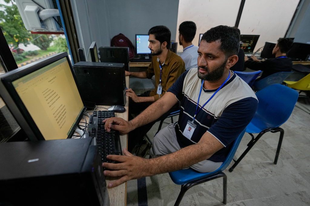 Hamza Ali, 28, who lost both legs in a road accident, attends a computer training class in Islamabad, Pakistan, Wednesday, July 22, 2026. (AP Photo/Anjum Naveed)