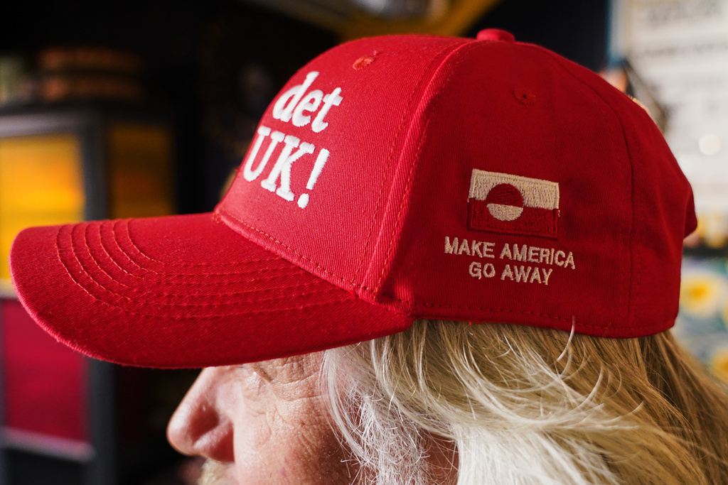 Store owner Jesper Rabe Tonnesen wears a red cap for sale that he created with the slogans "Make America go away," on the side, and on the front: "Nu det NUUK!," a twist on the Danish phrase “Nu det nok,” meaning “Now it’s enough,” substituting Nuuk, Greenland’s tiny capital, in Copenhagen, Denmark, Thursday, Jan. 15, 2026. (AP Photo/James Brooks)