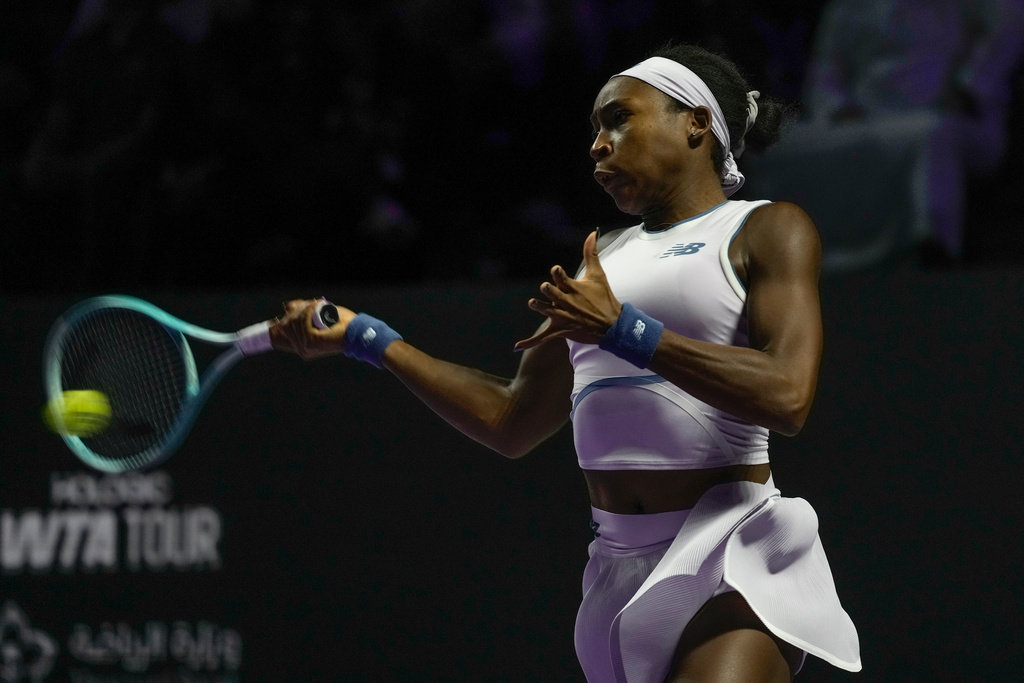 Coco Gauff of the United States plays a shot against Jasmine Paolini of Italy during their women's singles match at the WTA tennis finals in Riyadh, Saudi Arabia, Tuesday, Nov. 4, 2025. (AP Photo/ Fatima Shbair)