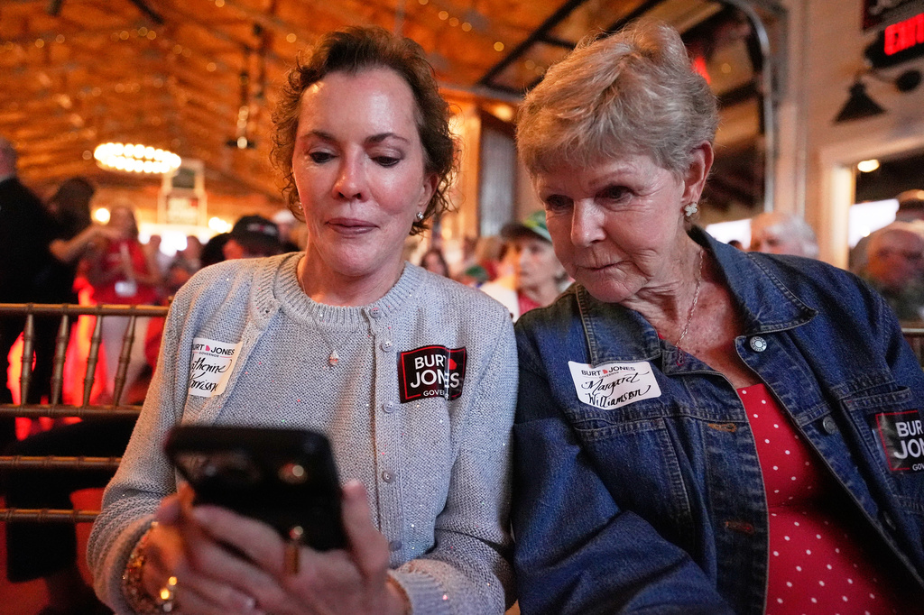 Catherine Harrison, left, and Margaret Williamson view election results during a runoff election night watch party for Republican gubernatorial candidate Burt Jones, Tuesday, June 16, 2026, in Jackson, Ga. (AP Photo/Mike Stewart)