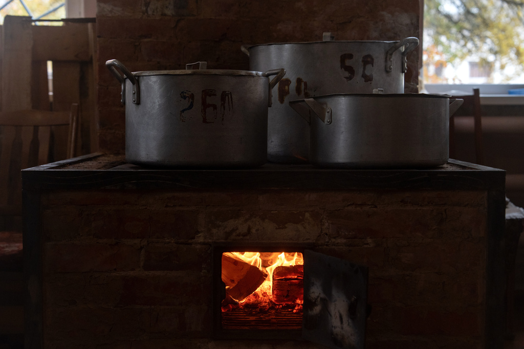 Food cooks on a wood-burning stove at Shostka Central District Hospital during a rolling blackout, Thursday, Oct. 16, 2025, in Shostka, Ukraine. (AP Photo/Julia Demaree Nikhinson)