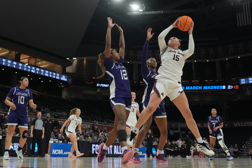 Missouri State forward Maiesha Washington (15) grabs a rebound over Stephen F. Austin guard Kaylinn Kemp (12) during the first half in a First Four college basketball game in the NCAA Tournament, Wednesday, March 18, 20206, in Austin, Texas. (AP Photo/Eric Gay)
