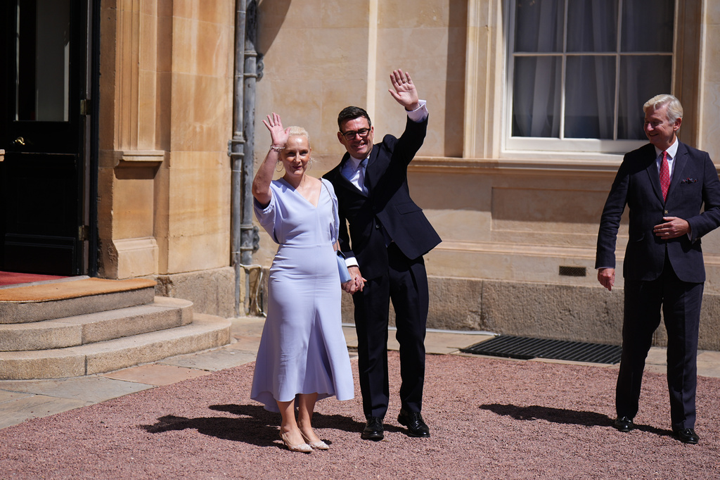 Sir Clive Alderton, Principal Private Secretary to the King and Queen, right, with Prime Minister Andy Burnham and his wife Marie-France van Heel, as they leave Buckingham Palace in London after an audience with King Charles III, where he was invited to become Prime Minister and form a new government, Monday July 20, 2026. (Aaron Chown/Pool Photo via AP)