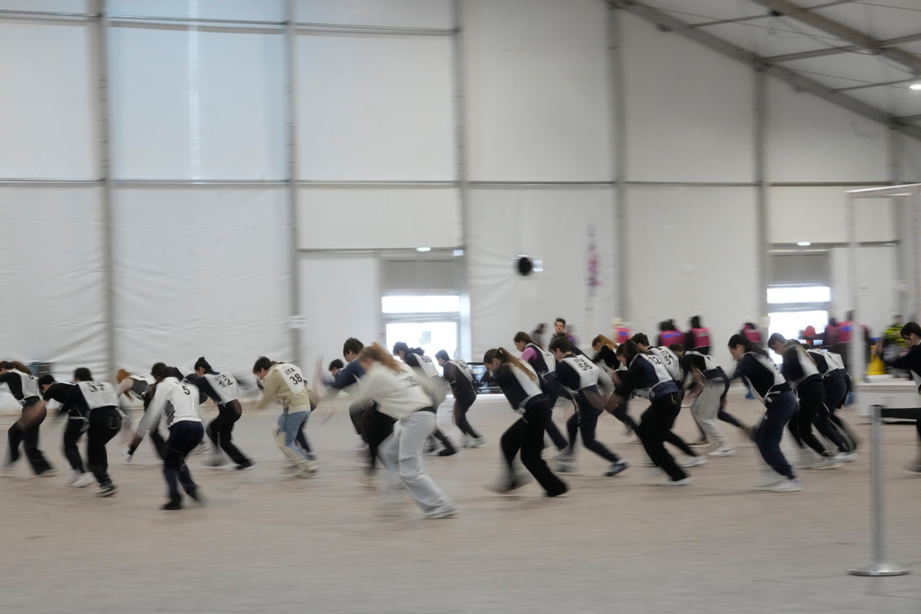 Volunteer dancers perform during rehearsals for the opening ceremony of the Milan Cortina 2026 Winter Olympic Games, at a compound in a big tent next to San Siro Stadium, in Milan, Italy, Saturday, Jan. 24, 2026. (AP Photo/Luca Bruno)