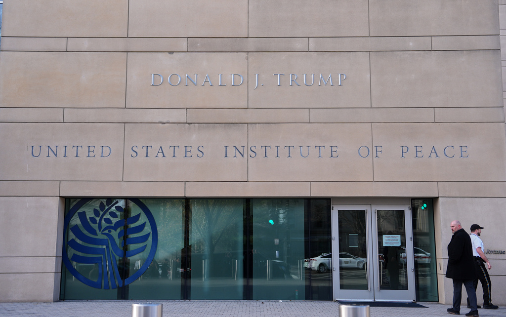 FILE - President Donald Trump's name is seen on the U.S. Institute of Peace building, Dec. 4, 2025, in Washington. (AP Photo/Evan Vucci, File)