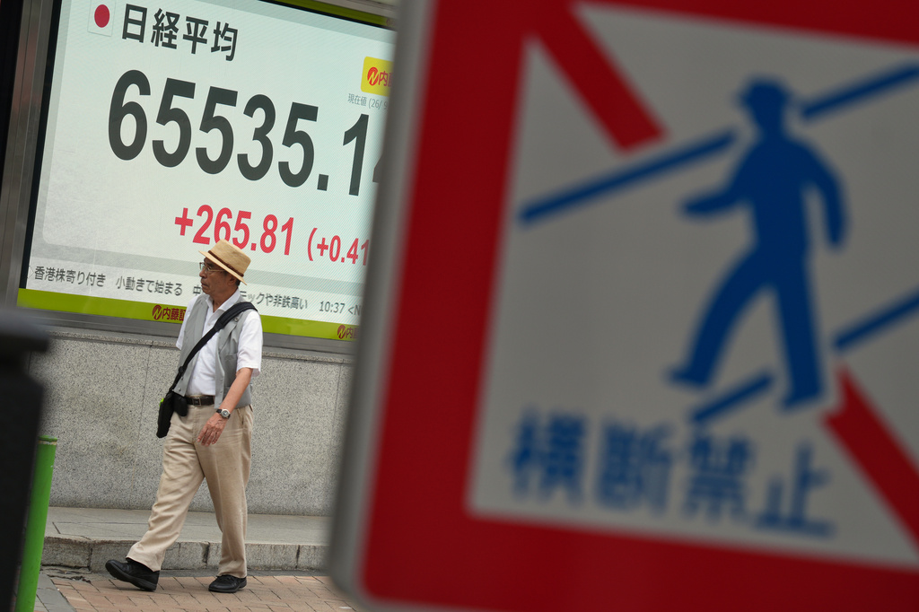 A person walks in front of an electronic stock board showing Japan's Nikkei index at a securities firm Wednesday, Sept. 9, 2026, in Tokyo. (AP Photo/Eugene Hoshiko)