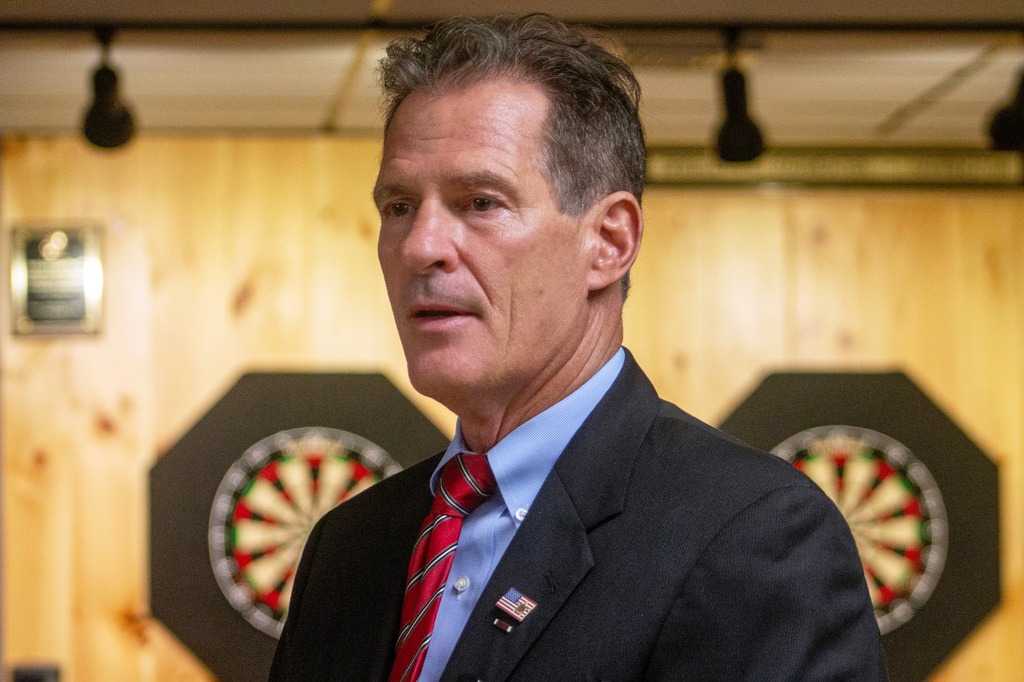 Former U.S. Sen. Scott Brown, a Republican who previously represented Massachusetts and is making his second run for Senate in New Hampshire, addresses voters at an American Legion hall in Londonderry, New Hampshire, on Thursday, Aug. 27, 2026. (AP Photo/Holly Ramer)