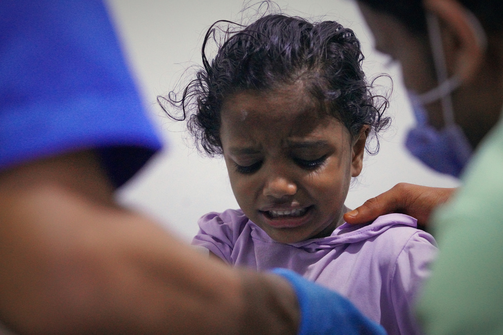 An injured child receives treatment at a hospital after a strike on the port of Mokha, Yemen, Friday, Aug. 14, 2026. (AP Photo/Abdulnasser Alseddik)