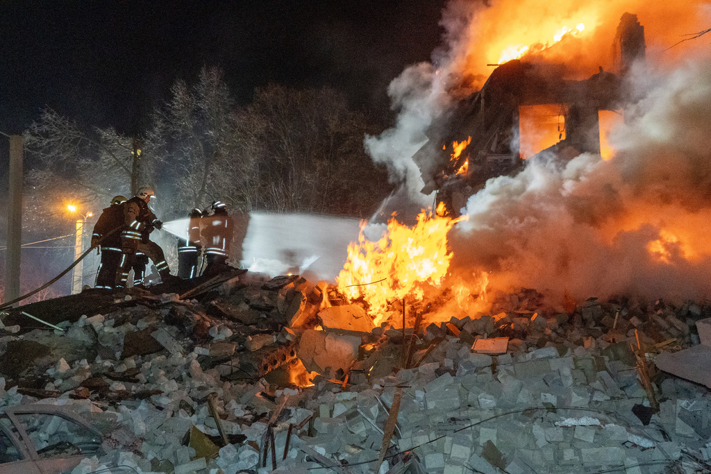Firefighters put out the fire in an multi-storey apartment building following a Russian missile attack in Kharkiv, Ukraine, Saturday, March 7, 2026. (AP Photo/Andrii Marienko)