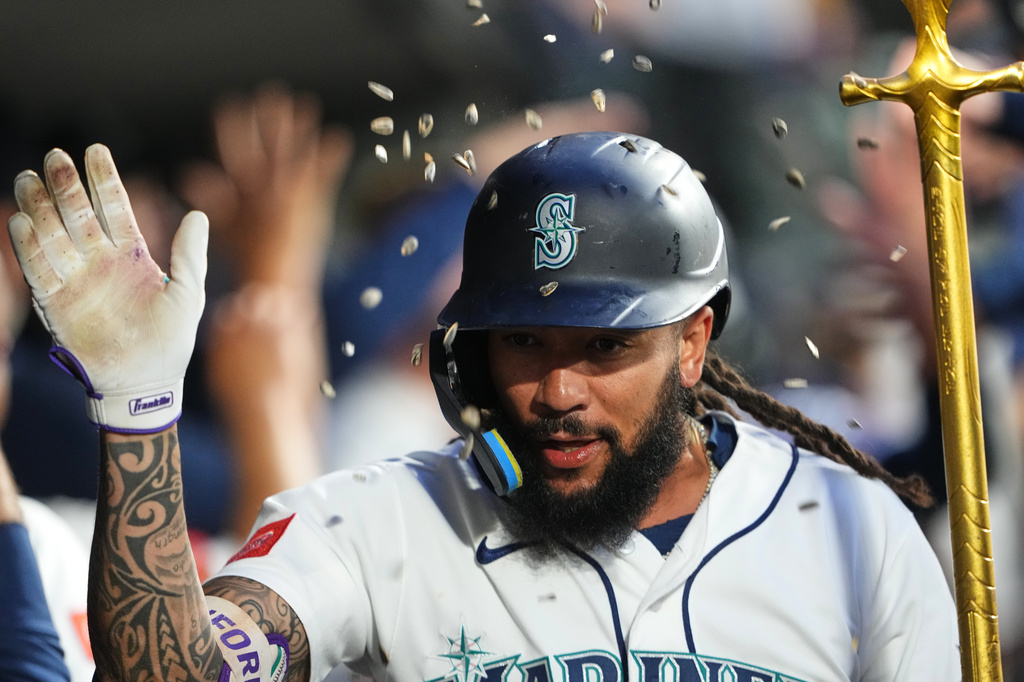 Seattle Mariners' J.P. Crawford celebrates in the dugout after hitting a two-run home run against the Atlanta Braves during the sixth inning of a baseball game, Monday, May 4, 2026, in Seattle. (AP Photo/Lindsey Wasson)