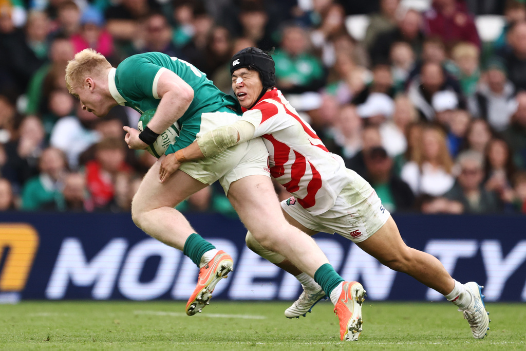 Ireland's Jamie Osborne is tackled by Japan's Kippei Ishida during the rugby union Nations Series match between Ireland and Japan in Dublin, Saturday, Nov. 8, 2025 . (AP Photo/Peter Morrison)