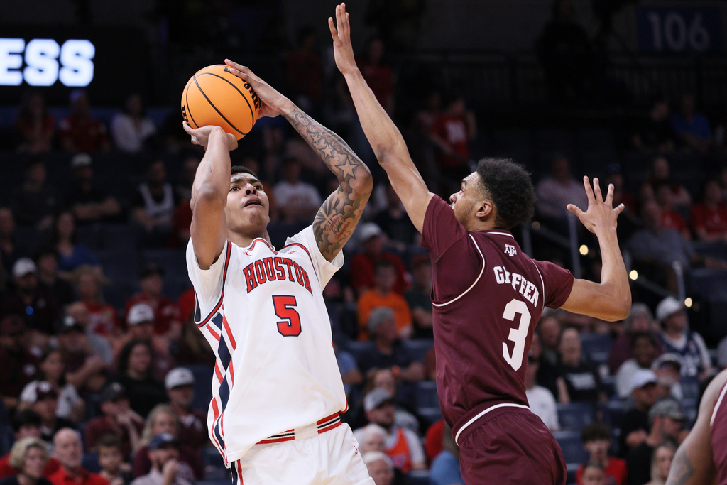 Houston center Chris Cenac Jr. (5) looks to shoot over Texas A&M guard Rylan Griffen (3) during the first half in the second round of the NCAA college basketball tournament Saturday, March 21, 2026, in Oklahoma City, Okla. (AP Photo/Nate Billings)