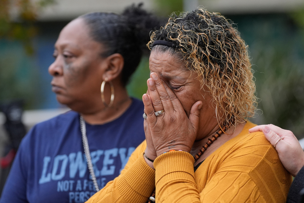Bernice Bass, left, and Teresa Spivey, family members of Patrice Williams, who was hosting a party for her daughter where gunfire broke out, react while being interviewed in Stockton, Calif., Monday, Dec. 1, 2025. (AP Photo/Jeff Chiu)