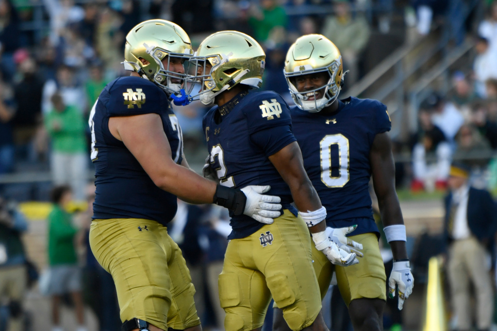 Notre Dame wide receiver Will Pauling (2) celebrates with teammates Billy Schrauth, left, and Malachi Fields (0) after catching a touchdown pass during the first quarter of an NCAA college football game against North Carolina State, Saturday, Oct. 11, 2025, in South Bend, Ind. (AP Photo/Paul Beaty)
