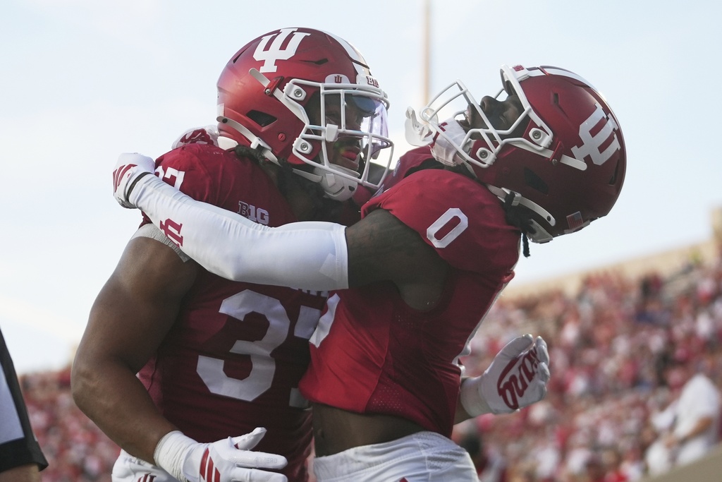 Indiana wide receiver Jonathan Brady (0) celebrates a touchdown catch with tight end Riley Nowakowski during the first half of an NCAA college football game against Indiana State , Friday, Sept. 12, 2025, in Bloomington, Ind. (AP Photo/Darron Cummings)