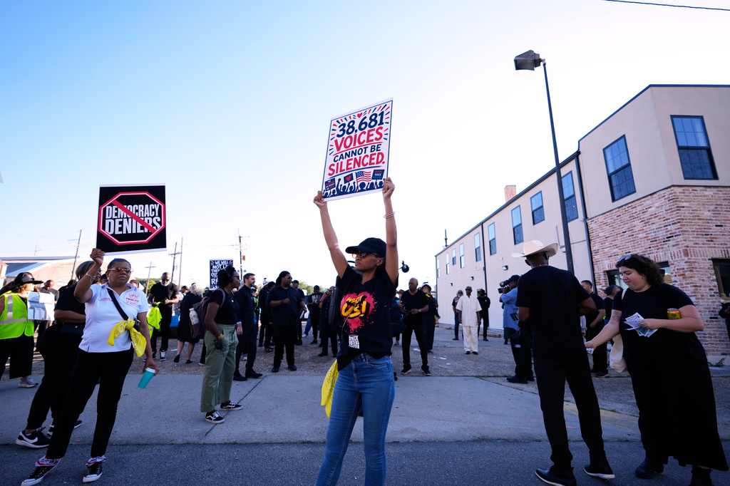 People protesting against Louisiana Governor Jeff Landry gather outside Orleans Parish criminal court on the day Calvin Duncan, an exoneree who was elected Orleans Parish clerk of criminal court, took his first day in office, Monday, May 4, 2026, in New Orleans. (AP Photo/Gerald Herbert)