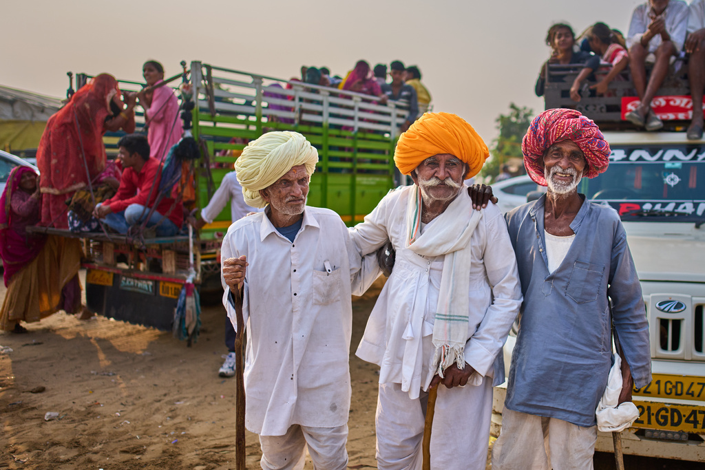 Camel herders react to the camera as they arrive at the annual cattle fair in Pushkar, in the western Indian state of Rajasthan, Monday, Oct. 27, 2025. (AP Photo/Rajesh Kumar Singh)