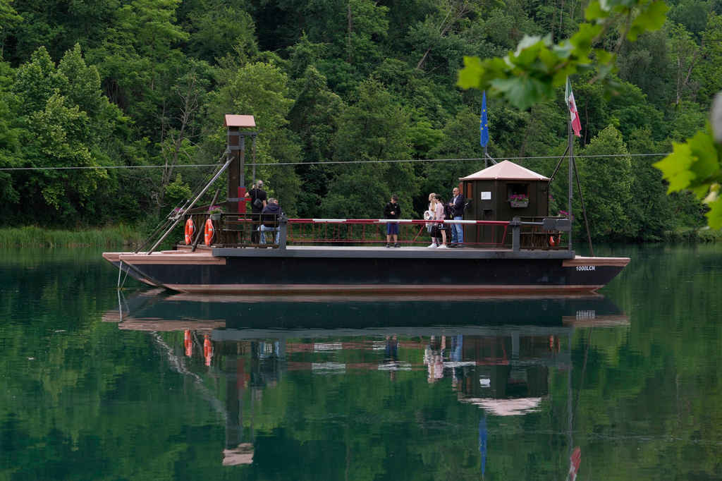 Commuters board the “Da Vinci Ferry,” a hand-operated ferry of a type sketched by Leonardo da Vinci around 1513, on the Adda River between the provinces of Lecco and Bergamo, in Imbersago, Italy, Thursday, June 4, 2026. (AP Photo/Luca Bruno)
