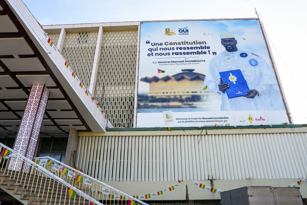A large campaign banner showing Guinea's interim president, Col. Mamadi Doumbouya, is displayed on a public building in Conakry, Guinea, Wednesday, Sept. 17, 2025. (AP Photo/Misper Apawu)
