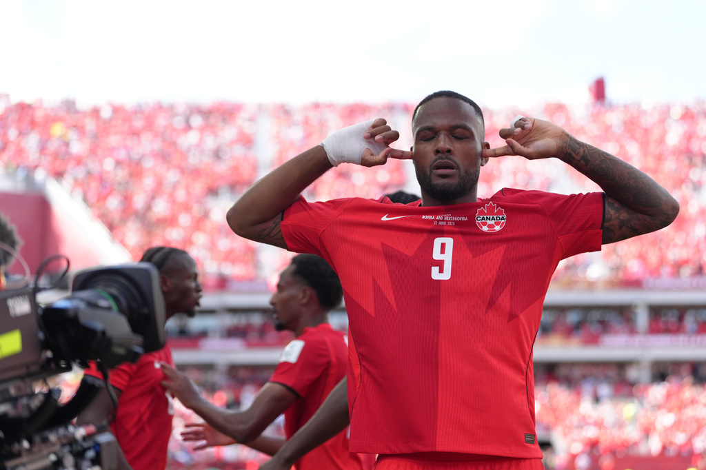 Canada's Cyle Larin (9) celebrates after scoring his sides first goal of the game in the second half of the World Cup Group B soccer match between Canada and Bosnia, Friday, June 12, 2026, in Toronto. ( (AP Photo/Sam Balkansky)