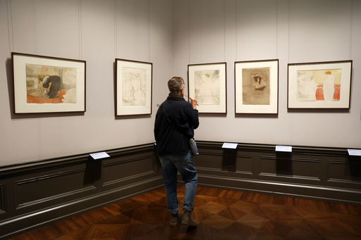 A visitor looks on the painting titled "Woman with Hand Mirror, plate 6 " from 1864-1901 by Henri de Toulouse-Lautrec at a press preview for the exhibition "The Scharf Collection: Goya – Monet – Cezanne – Bonnard – Grosse" at the Alte Nationalgalerie museum in Berlin, Wednesday, Oct. 22, 2025. (AP Photo/Maryam Majd) A visitor looks on the painting titled "Woman with Hand Mirror, plate 6 " from 1864-1901 by Henri de Toulouse-Lautrec at a press preview for the exhibition "The Scharf Collection: Goya – Monet – Cezanne – Bonnard – Grosse" at the Alte Nationalgalerie museum in Berlin, Wednesday, Oct. 22, 2025. (AP Photo/Maryam Majd)
