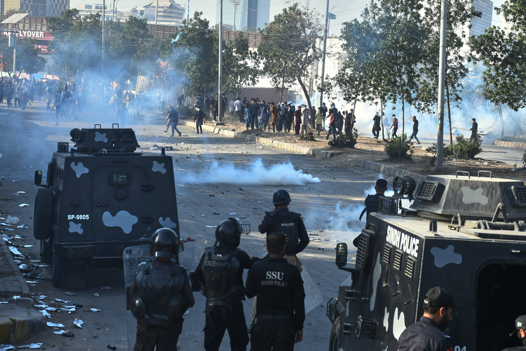 Police officers fire tear gas shell to disperse Shiite Muslims during a protest to condemn the killing of Iranian Supreme Leader Ayatollah Ali Khamenei, in Karachi, Pakistan, Sunday, March 1, 2026. (AP Photo/Ali Raza)