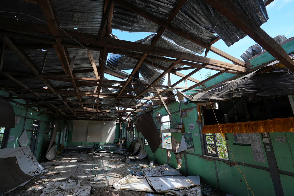 In this photo taken during a trip supervised by pro-military Myanmar media, a damaged office of the Union Solidarity and Development Party (USDP) is seen in Kawnghkio township, northern Shan State, Myanmar, Friday, Oct. 10, 2025. (AP Photo/Aung Shine Oo)