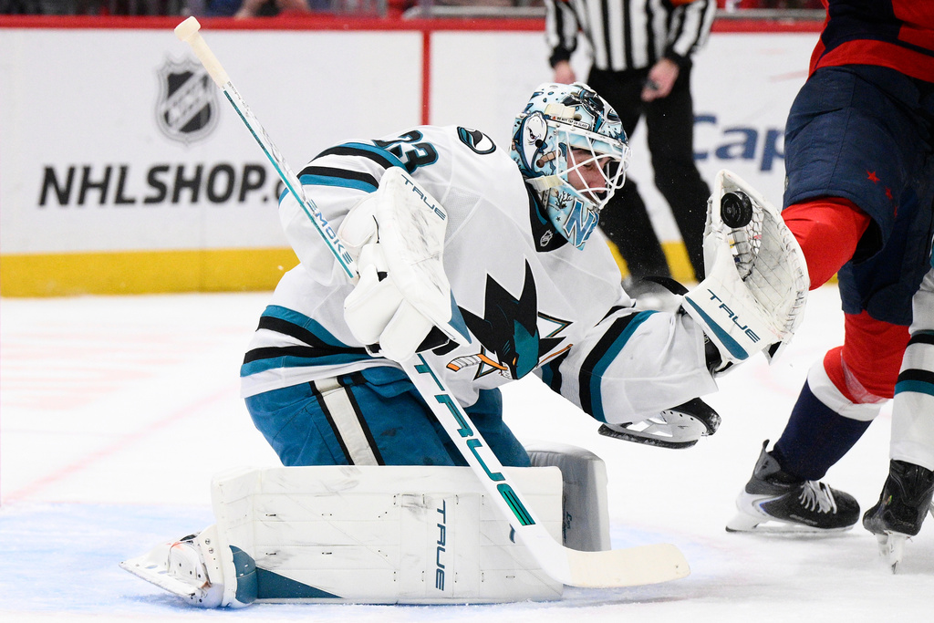San Jose Sharks goaltender Alex Nedeljkovic (33) stops the puck during the first period of an NHL hockey game against the Washington Capitals, Thursday, Jan. 15, 2026, in Washington. (AP Photo/Nick Wass)